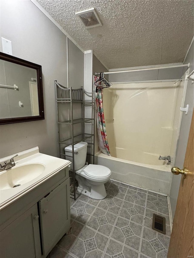 full bathroom with vanity, tile patterned flooring, toilet, a textured ceiling, and shower / tub combo