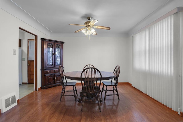 dining room with ceiling fan and dark hardwood / wood-style floors