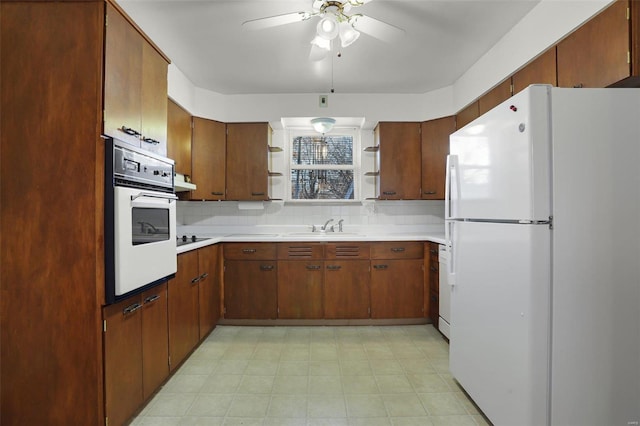 kitchen with decorative backsplash, sink, ceiling fan, and white appliances