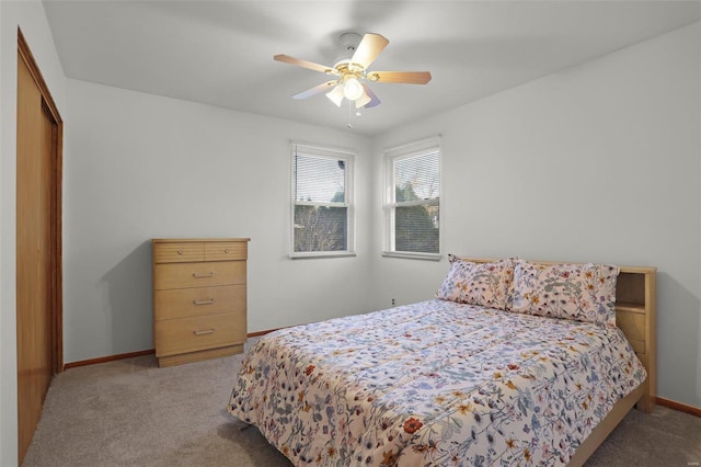 carpeted bedroom with ceiling fan and a closet