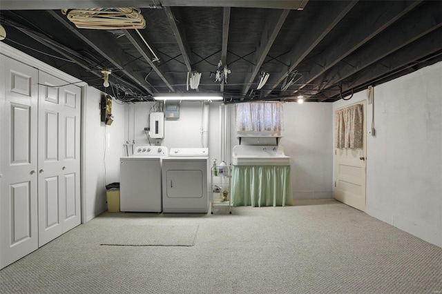 basement with carpet, electric panel, and washing machine and clothes dryer