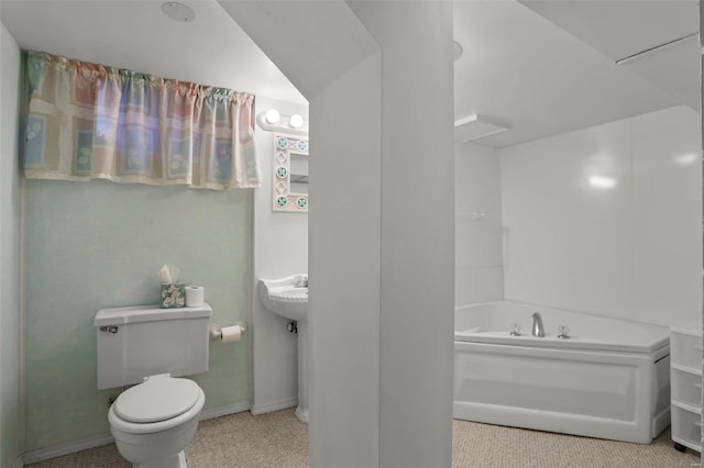 bathroom featuring a bathtub, lofted ceiling, and toilet