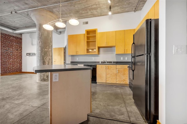 kitchen with black appliances, decorative light fixtures, a center island, and sink