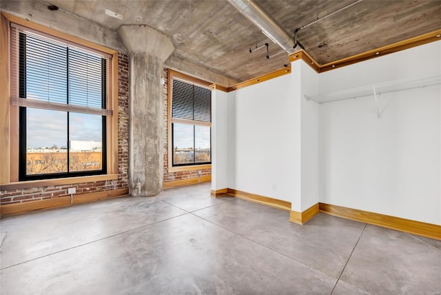 unfurnished room with concrete floors