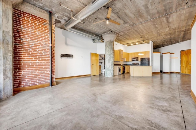 garage featuring ceiling fan and black fridge