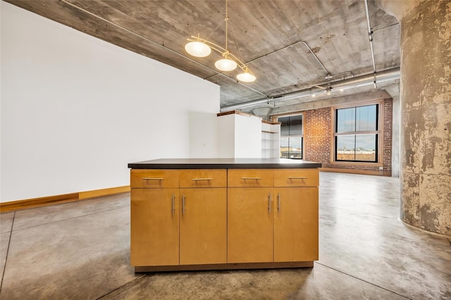 kitchen featuring concrete floors and ceiling fan