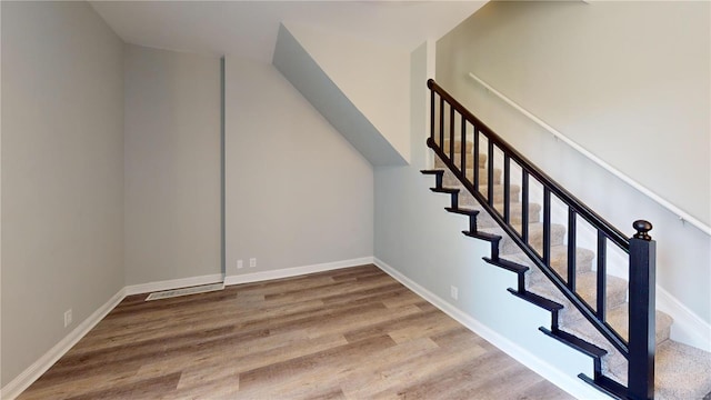 stairs with hardwood / wood-style floors