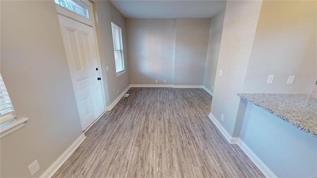 entryway with hardwood / wood-style floors and a healthy amount of sunlight