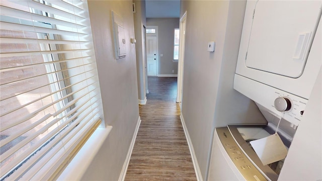 corridor featuring hardwood / wood-style floors and stacked washer and clothes dryer