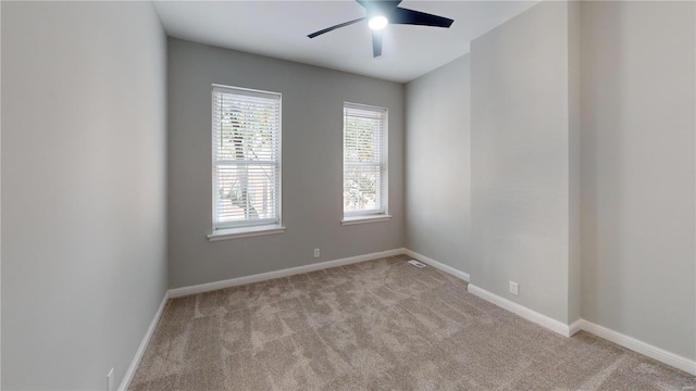 spare room featuring ceiling fan and light colored carpet