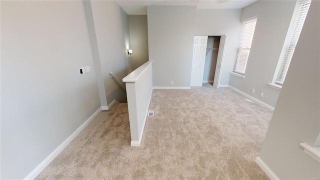 spare room with light carpet