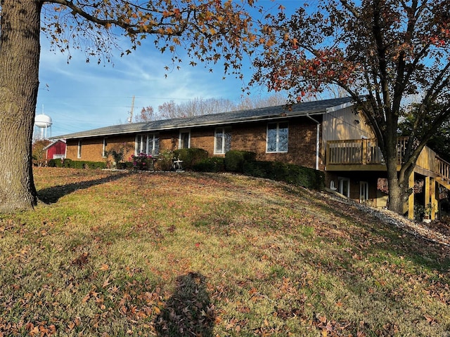 back of house with a lawn and a wooden deck