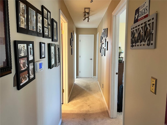 hallway featuring light carpet