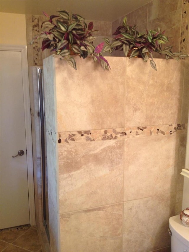 bathroom with tile patterned floors and toilet