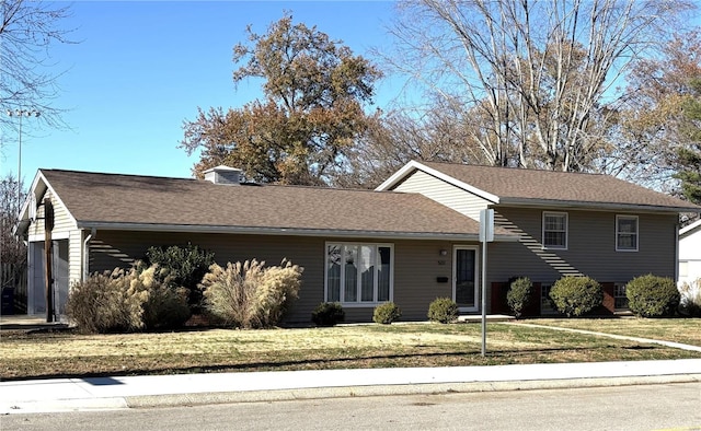 view of front of house with a garage and a front yard