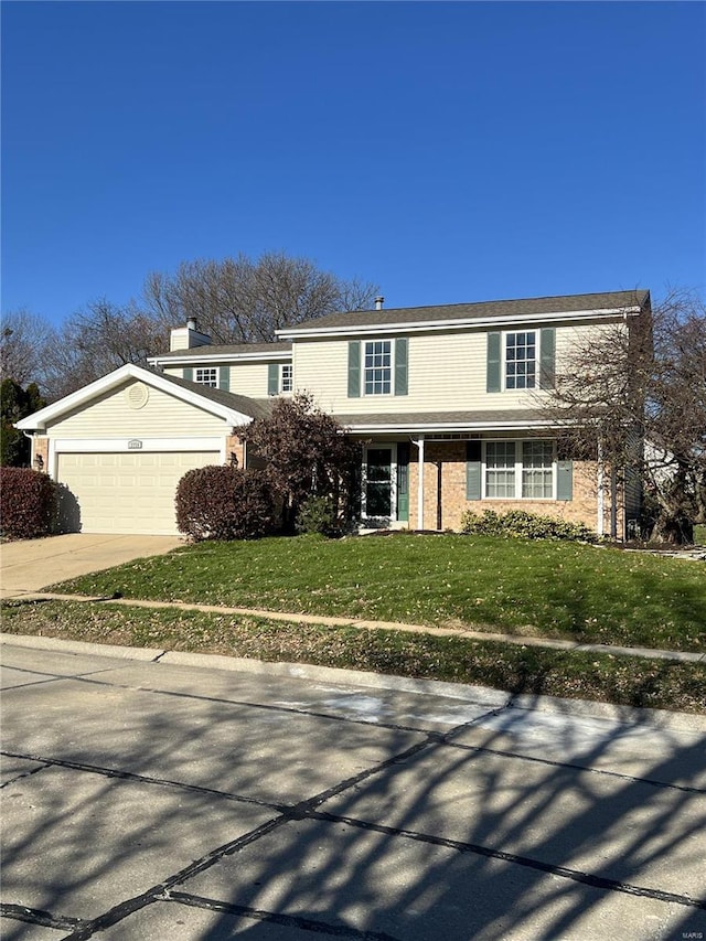 view of front property featuring a front lawn and a garage