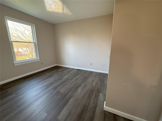 unfurnished room with dark hardwood / wood-style floors