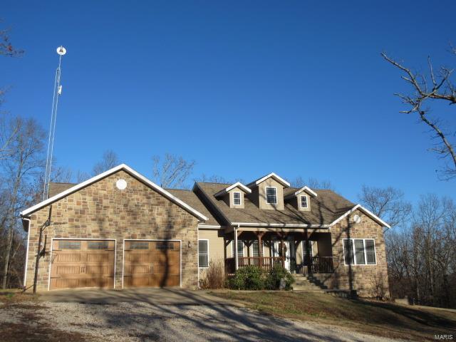 view of front of house featuring a porch and a garage