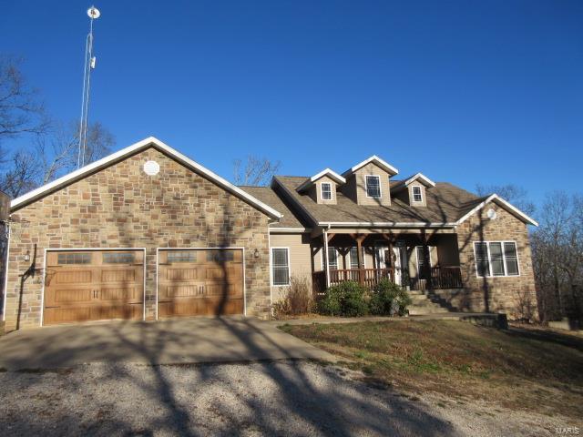 view of front facade featuring covered porch and a garage