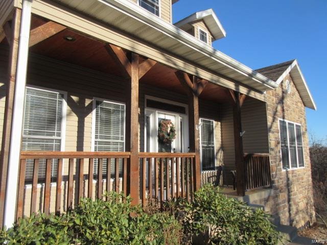 doorway to property featuring a porch