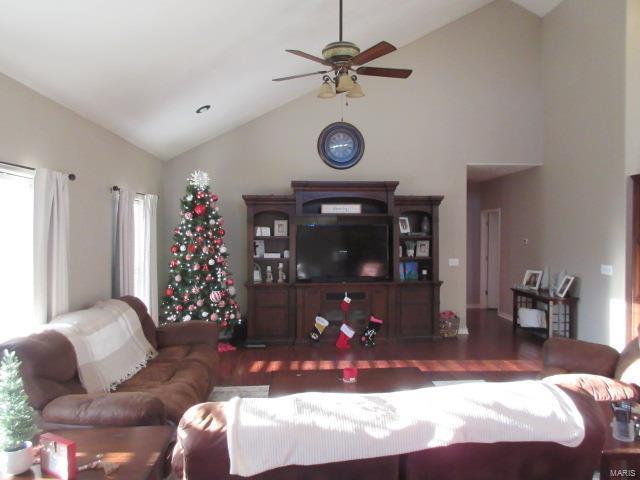 living room with ceiling fan and high vaulted ceiling