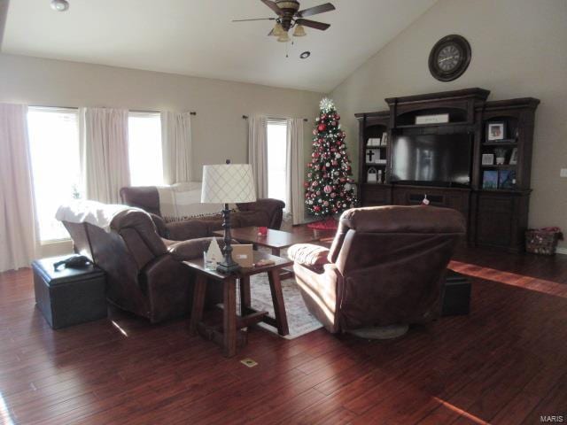 living room featuring plenty of natural light, dark hardwood / wood-style floors, ceiling fan, and vaulted ceiling