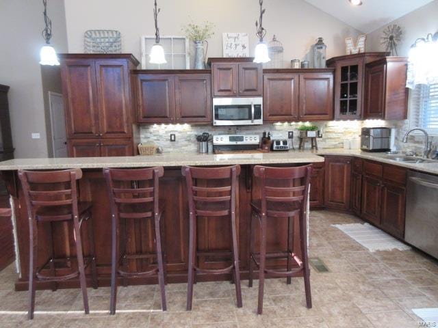 kitchen featuring sink, hanging light fixtures, and appliances with stainless steel finishes