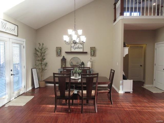 dining room with dark hardwood / wood-style flooring, high vaulted ceiling, french doors, and an inviting chandelier