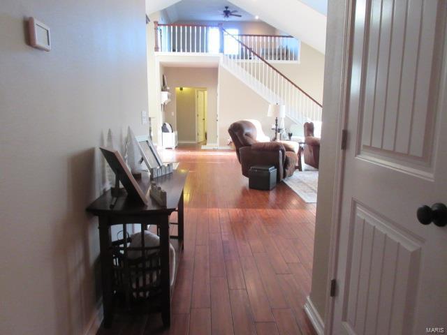 interior space with hardwood / wood-style floors, ceiling fan, and a high ceiling