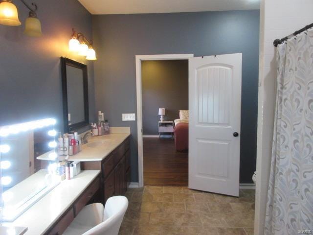 bathroom featuring curtained shower, hardwood / wood-style floors, vanity, and toilet