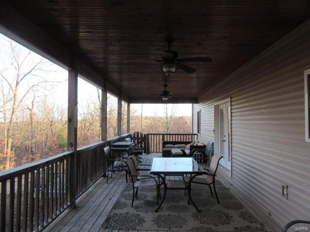 wooden deck featuring ceiling fan