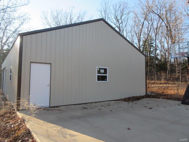 view of side of home with an outbuilding