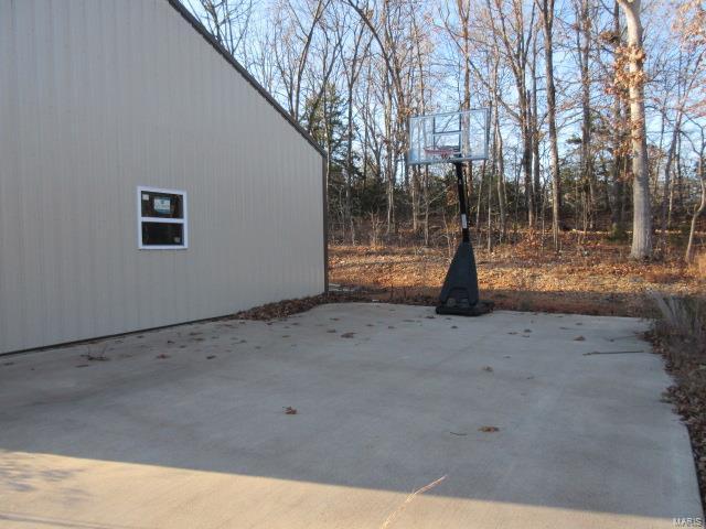 view of patio / terrace with basketball hoop