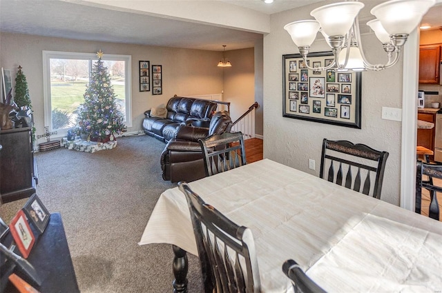 dining area featuring carpet and an inviting chandelier