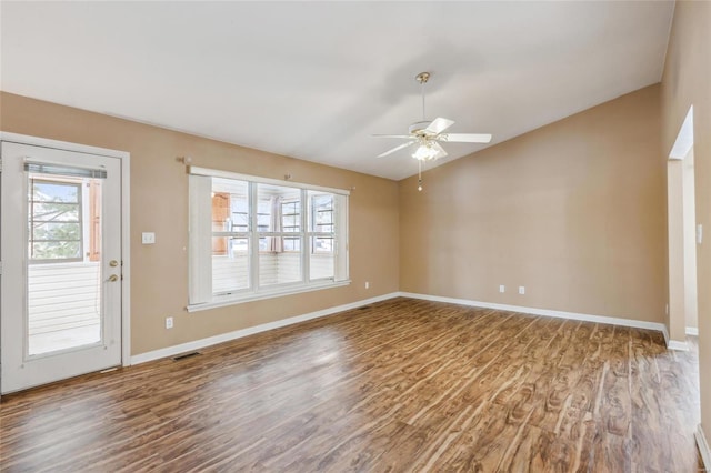 spare room featuring ceiling fan, wood-type flooring, and vaulted ceiling