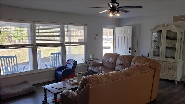 living room with ceiling fan, dark wood-type flooring, and a wealth of natural light