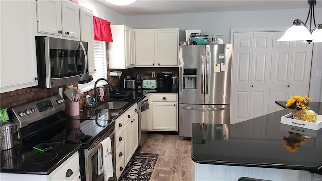 kitchen with white cabinetry, sink, appliances with stainless steel finishes, and dark wood-type flooring