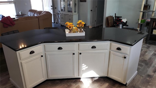 kitchen featuring white cabinets and dark wood-type flooring