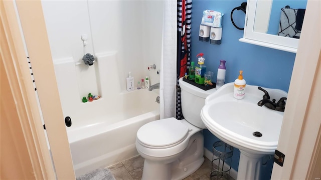 full bathroom with tile patterned floors, shower / bath combo, toilet, and sink