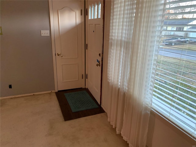 doorway featuring light carpet