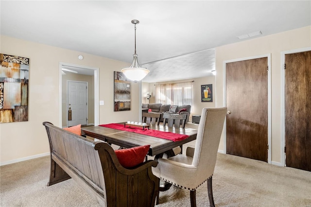 dining space with light colored carpet