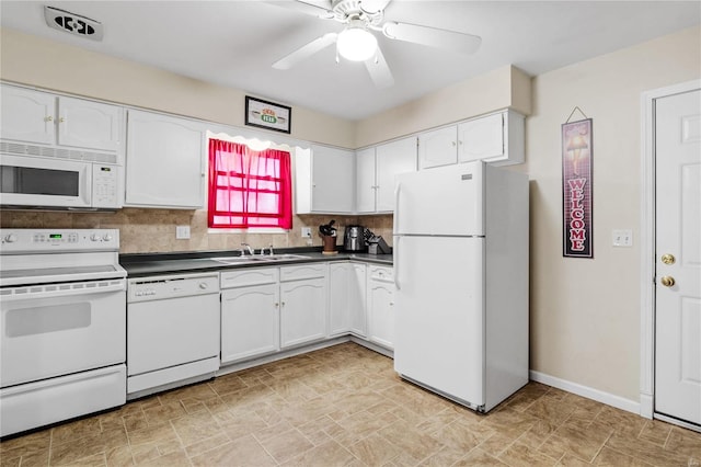 kitchen with tasteful backsplash, sink, white cabinets, and white appliances