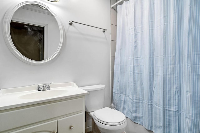 bathroom with walk in shower, vanity, and toilet