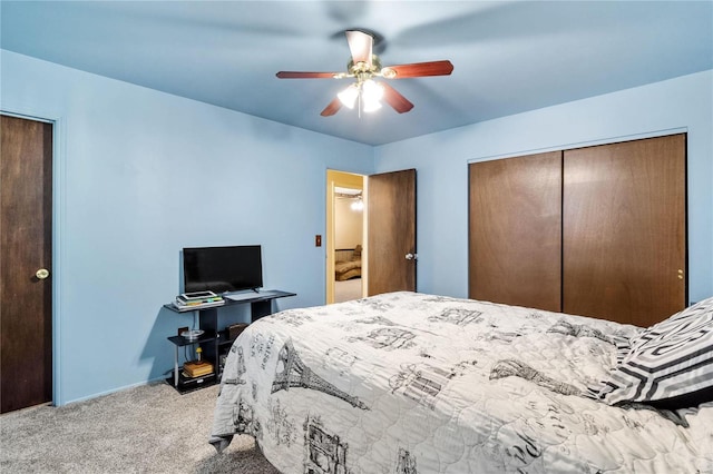 carpeted bedroom featuring ceiling fan and a closet