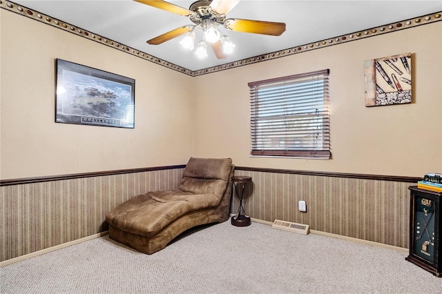 sitting room with ceiling fan and light carpet