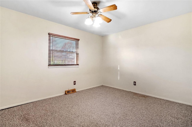 carpeted spare room featuring ceiling fan