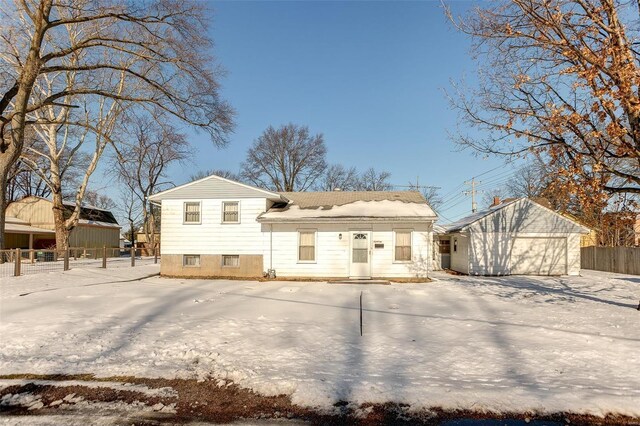 rear view of house with a garage