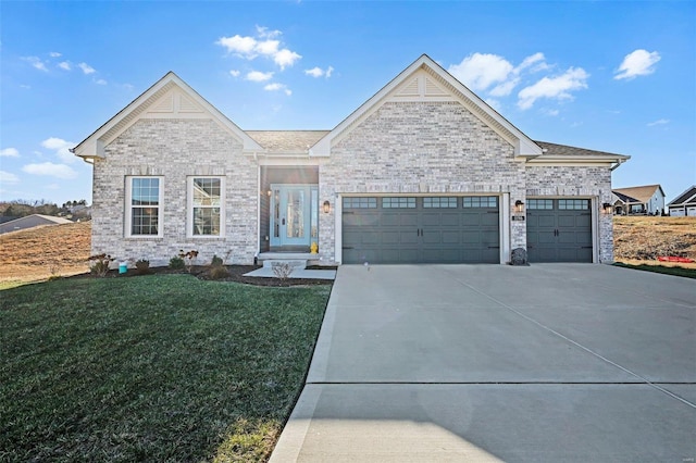 view of front of property with a front lawn and a garage