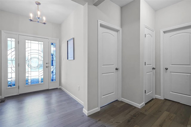 entrance foyer with dark hardwood / wood-style flooring and an inviting chandelier