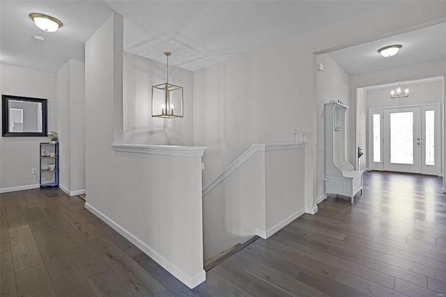 hall featuring a chandelier and dark hardwood / wood-style floors